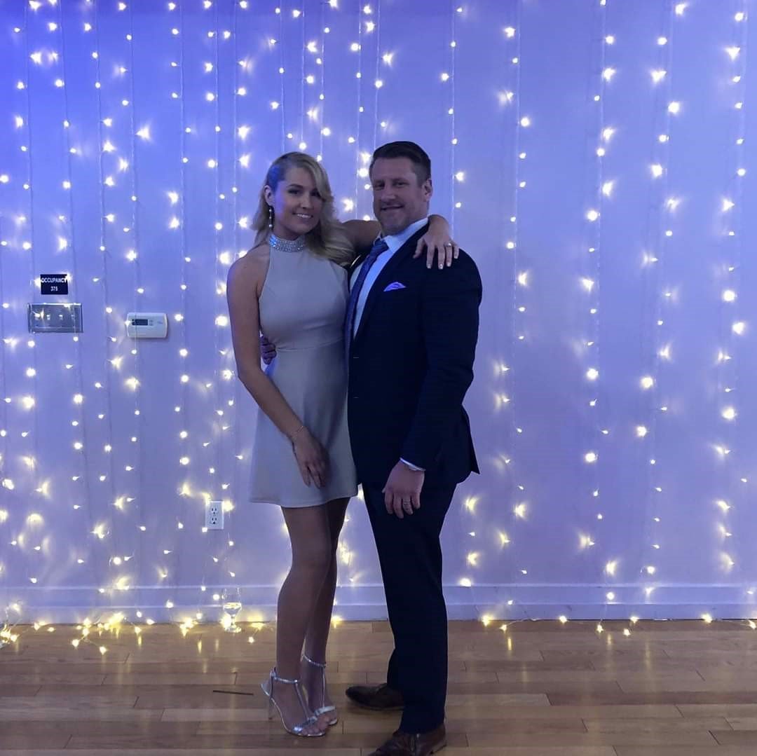 Kelly and his wife dressed nicely posing for a picture together